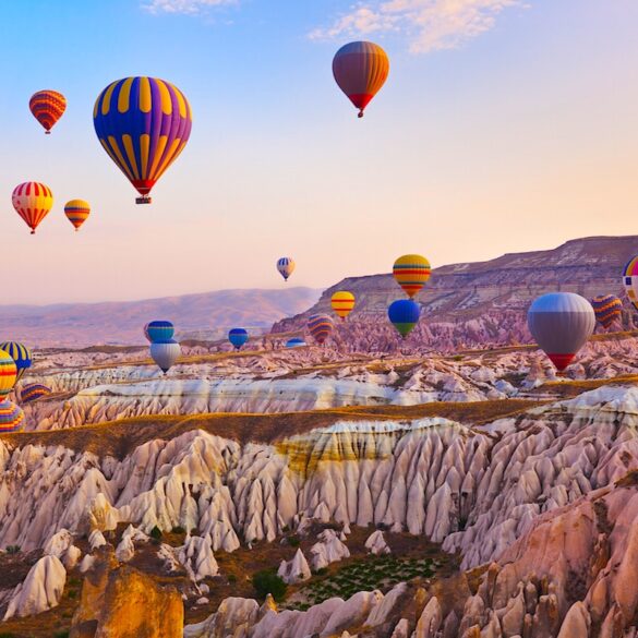 Hot air balloon flying over rock landscape at Cappadocia Turkey