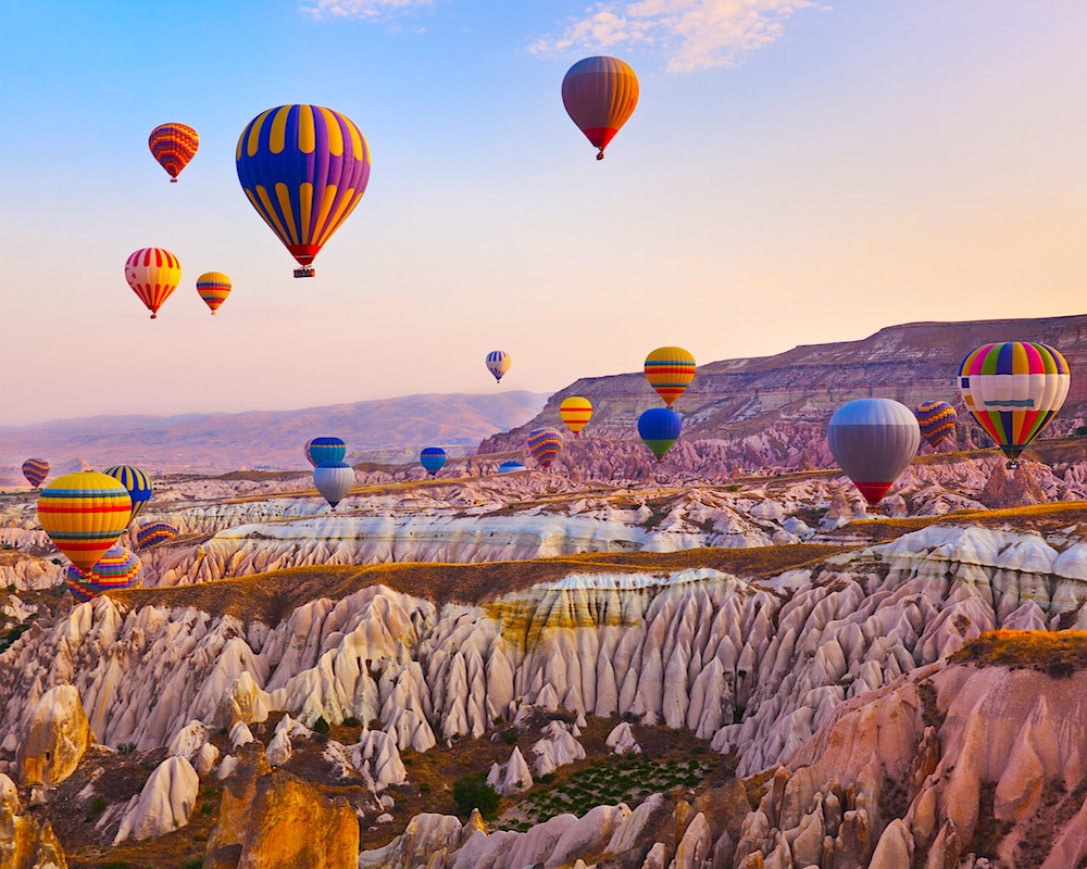 Hot air balloon flying over rock landscape at Cappadocia Turkey