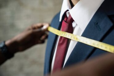 A man having a suit fitted at a tailor