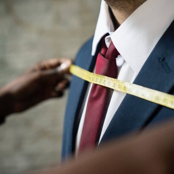 A man having a suit fitted at a tailor