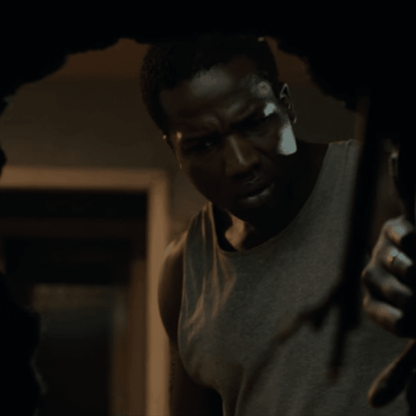 A man peers through a hole in the wall