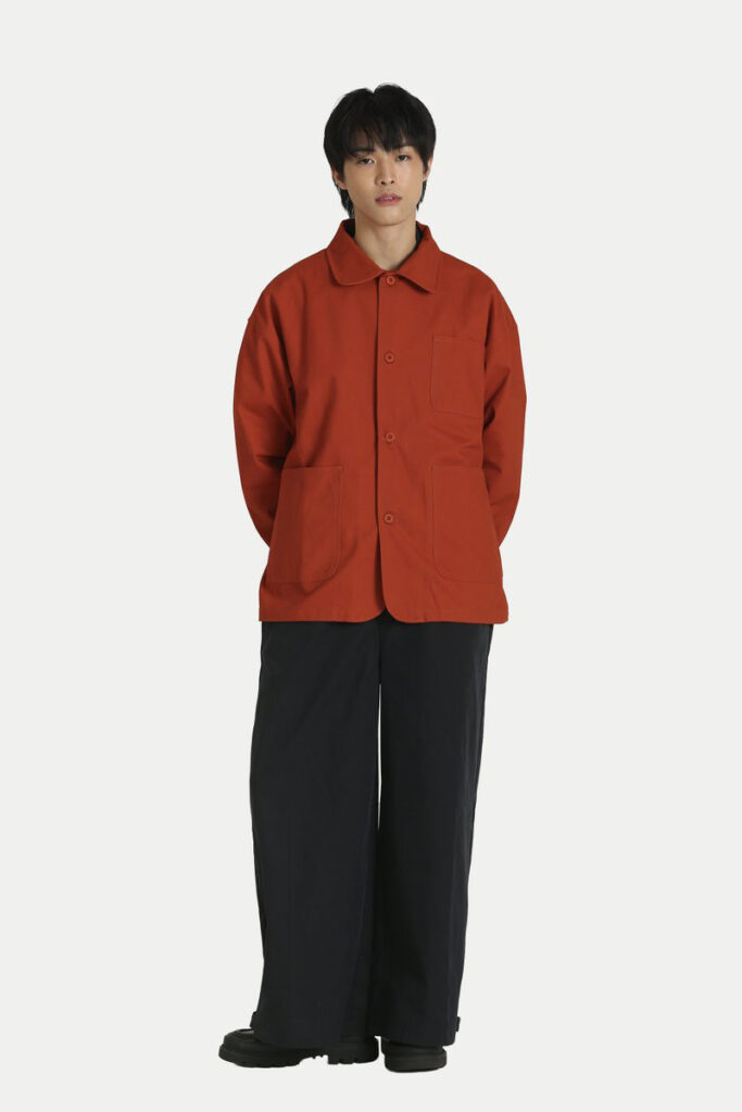 Arcade Men Hendrick Chore Jacket in rust, styled with wide-leg black trousers