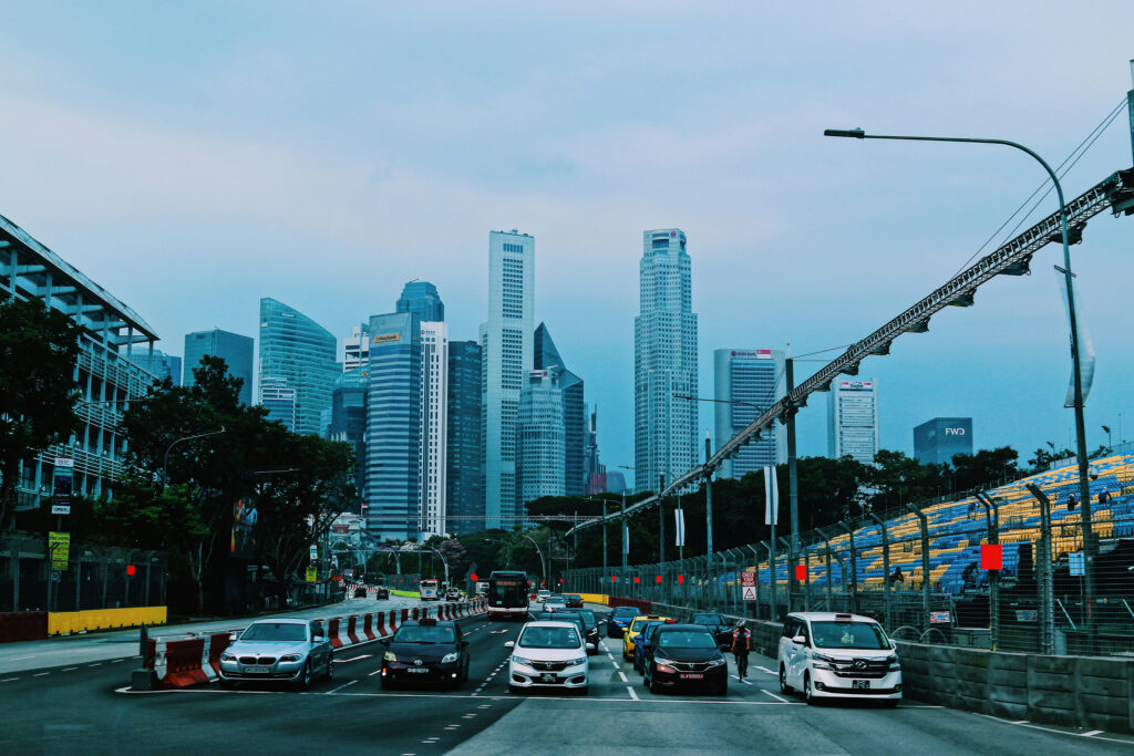 Cars on a busy road in Singapore with the CBD skyline in the background