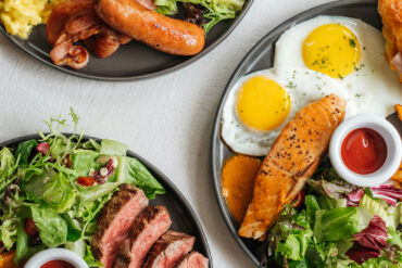 Brunch Orchard Road: hearty breakfast plates with sunny-side eggs, steak, salmon, sausages, salad and coffee.