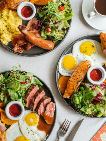 Brunch Orchard Road: hearty breakfast plates with sunny-side eggs, steak, salmon, sausages, salad and coffee.