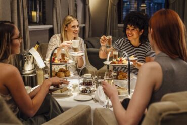 four women having high teas together