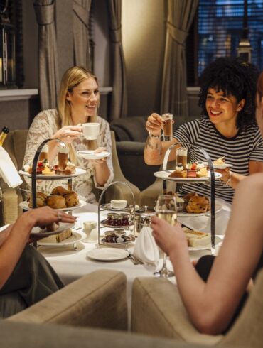 four women having high teas together