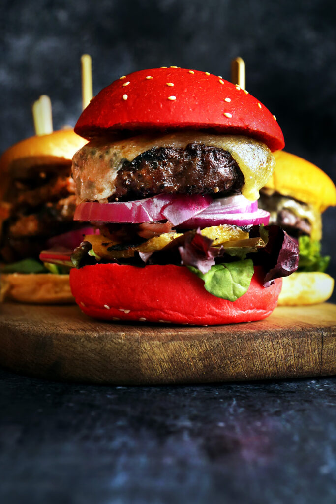 Ultimate Burger at Fireplace by Bedrock, One Holland Village, Singapore, featuring an Australian Wagyu beef patty in a beetroot bun with grilled pineapple and Monterey Jack cheese