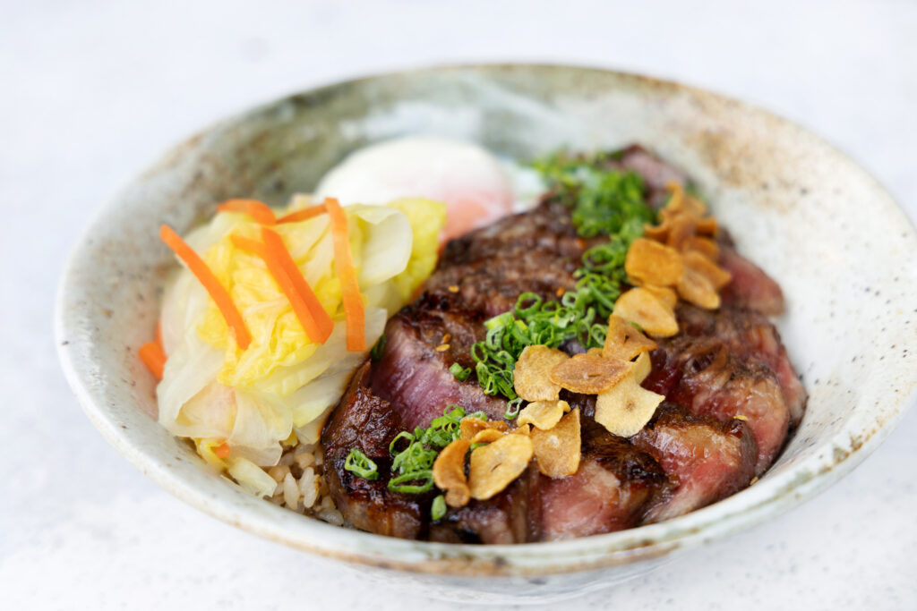 Wagyu Yakiniku Donburi set lunch at MIYOSHI by Fat Cow, Singapore, featuring charcoal-grilled wagyu over garlic fat rice with onsen egg and pickled vegetables