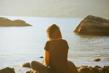 a lady meditating outdoors