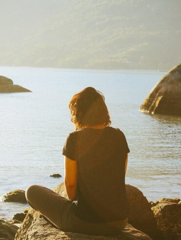 a lady meditating outdoors