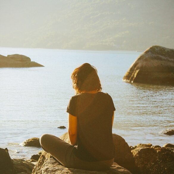 a lady meditating outdoors