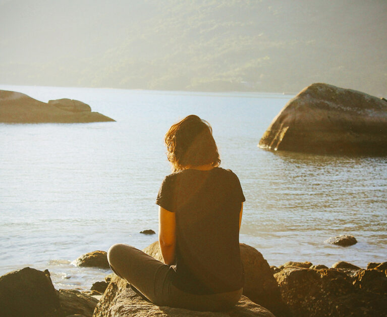 a lady meditating outdoors