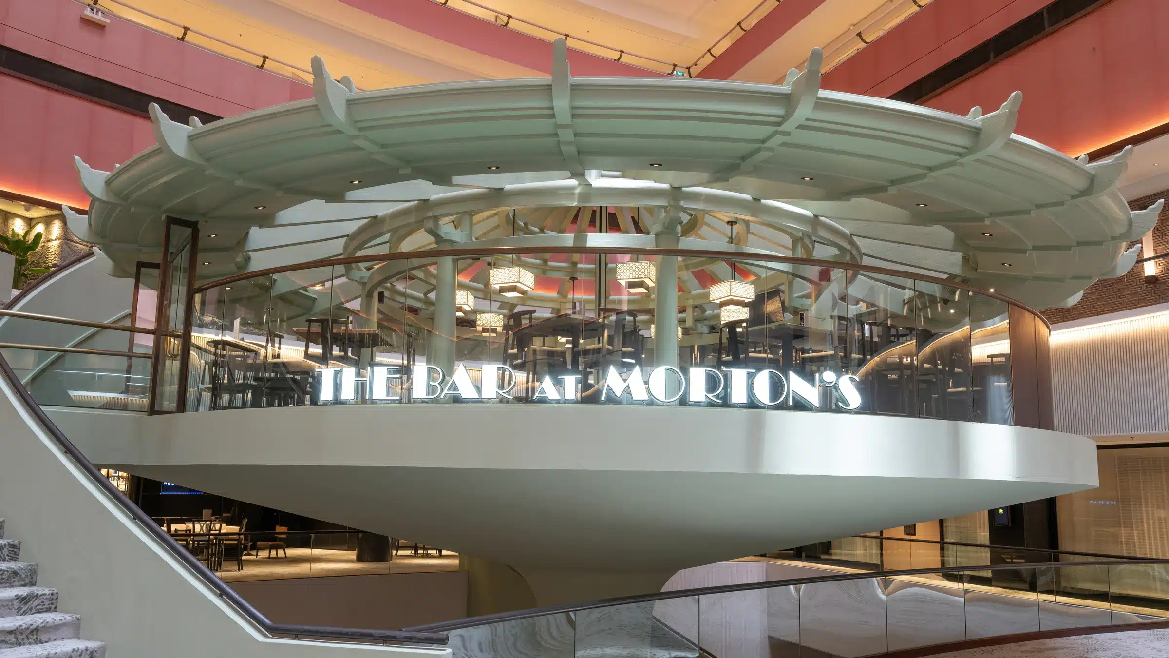 The Bar at Morton’s Singapore with stylish architecture, home to happy hour classics and filet mignon sandwiches.