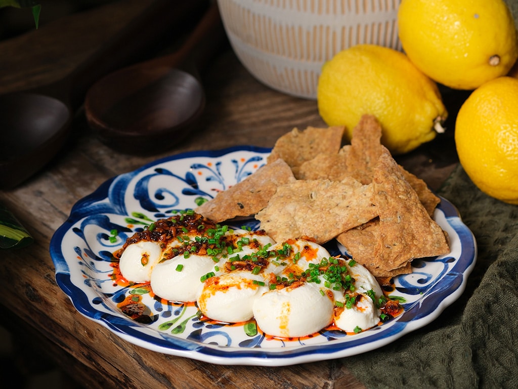 Spiced honey ricotta with crisp flatbread served on a hand-painted ceramic plate at Chicco Trattoria, Telok Ayer Singapore.