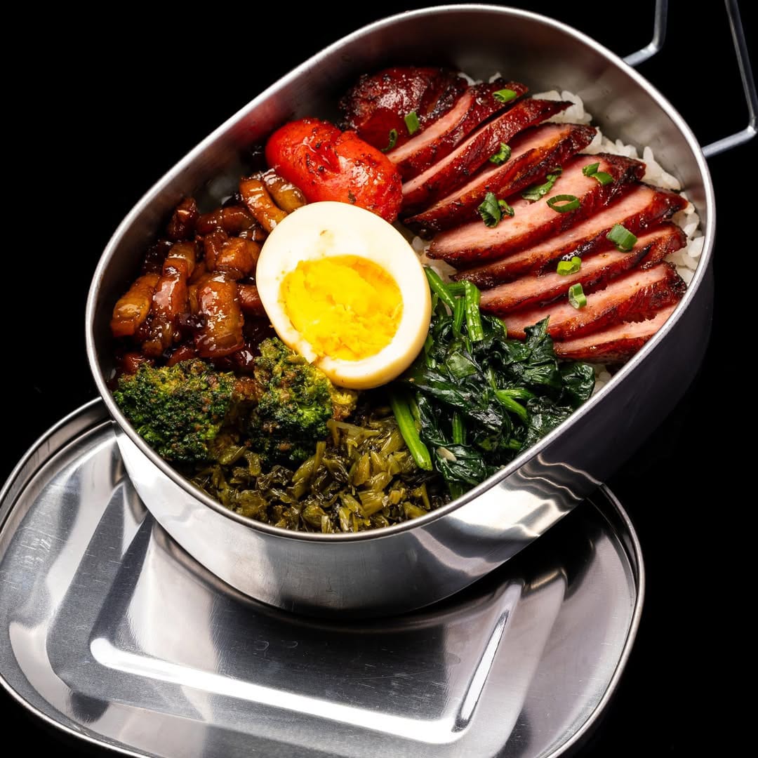 Traditional Taiwanese sausage rice bento with tea egg, pickled greens, braised pork, and vegetables from DongQu on Telok Ayer Street.
