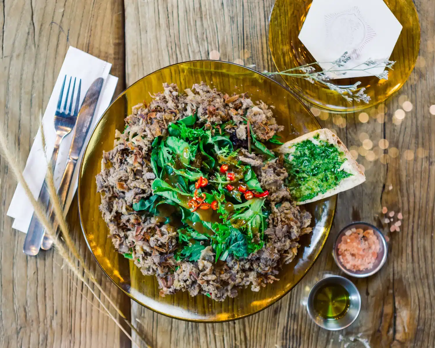 Hearty salad mixed greens, chilli dressing, and toasted bread topped with herb pesto at My Awesome Café, Telok Ayer, Singapore.