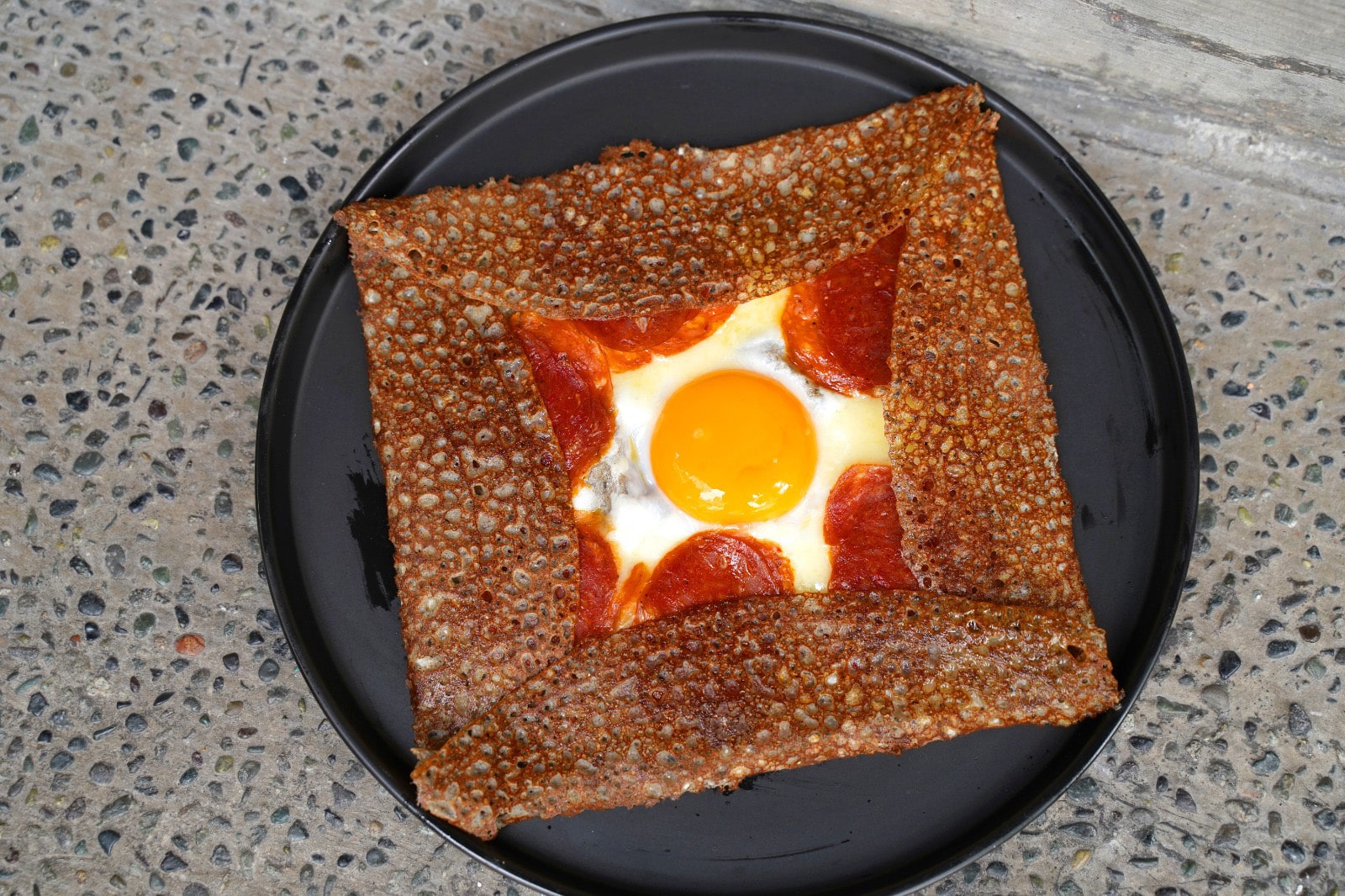 Savory buckwheat galette with sunny-side egg and pepperoni at French Fold, a Parisian-style crêperie in Telok Ayer.