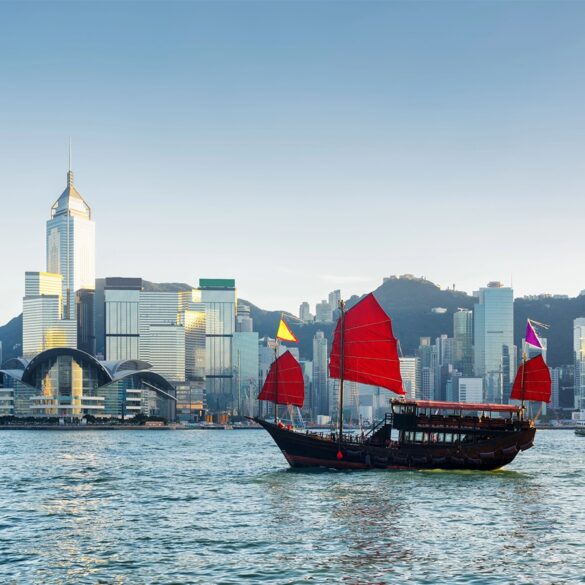 Traditional Chinese sailing ship in Victoria harbour in Hong Kong at evening