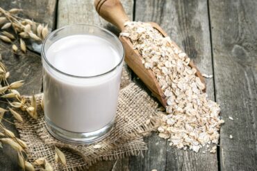 oats and oat milk on a wooden table