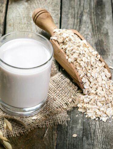 oats and oat milk on a wooden table