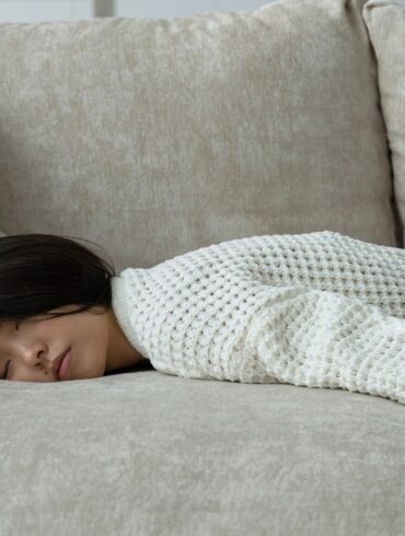 young asian girl sleeping on the couch