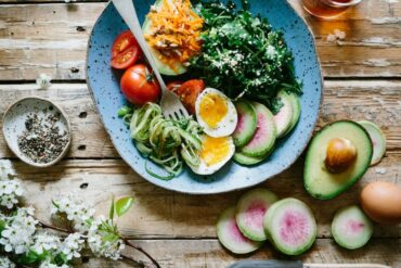 a photo of a healthy salad with fresh vegetables, drizzled with sesame oil, rice vinegar