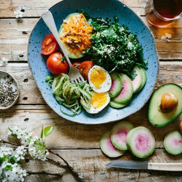 a photo of a healthy salad with fresh vegetables, drizzled with sesame oil, rice vinegar