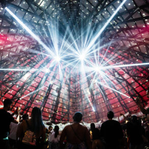 A lightshow at the ceiling of a dancefloor.