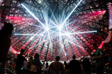 A lightshow at the ceiling of a dancefloor.