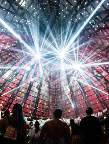 A lightshow at the ceiling of a dancefloor.