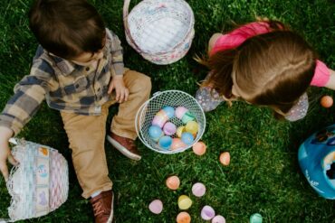 a photo of two children playing with eggs hunting on Easter