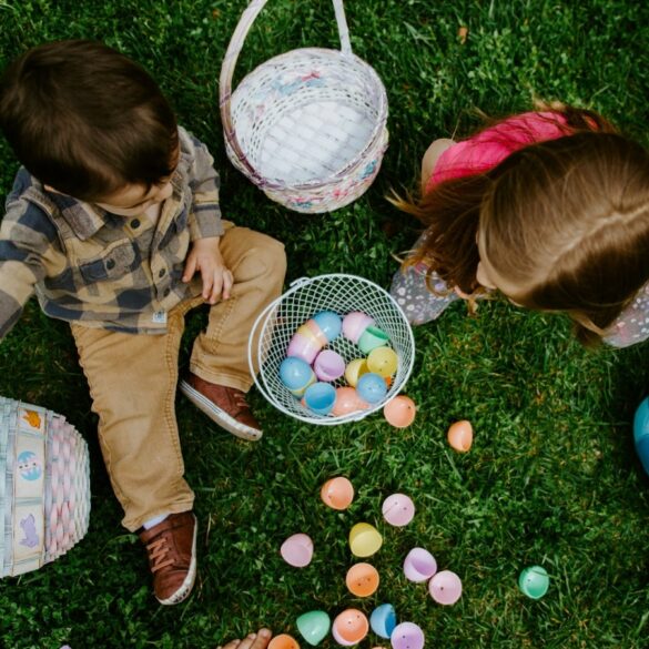 a photo of two children playing with eggs hunting on Easter