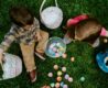 a photo of two children playing with eggs hunting on Easter