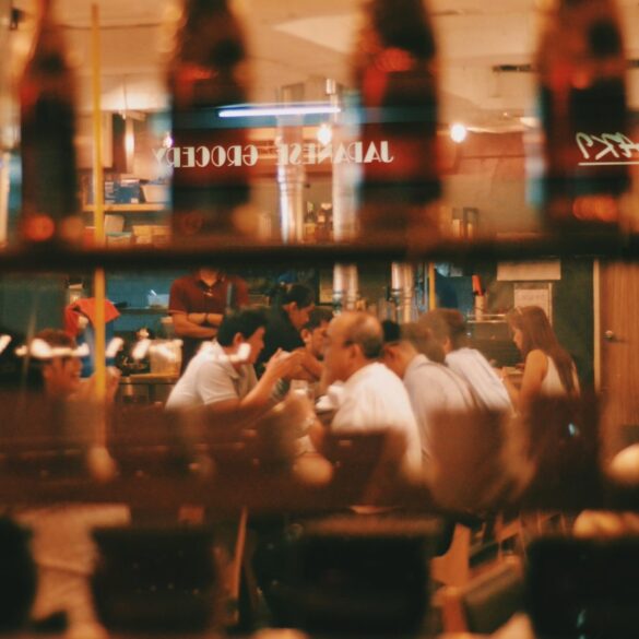 a photo of people dining in a restaurant through the window glass