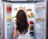 Rear View Of A Young Woman Taking Food To Eat From Refrigerator
