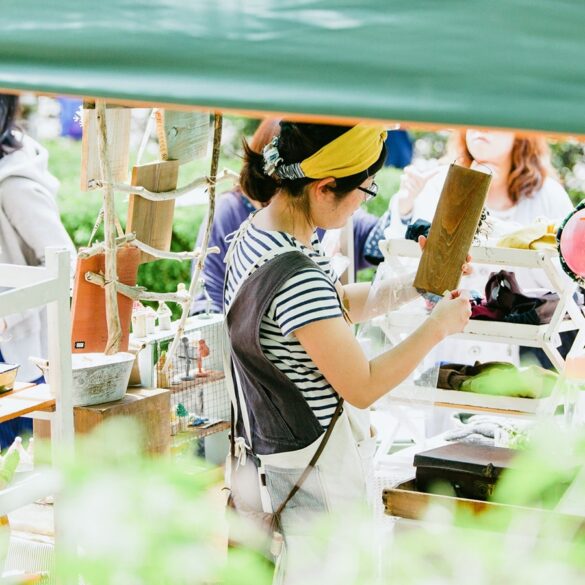 a photo of a Japanese woman tending to her stall at Higashi Betsuin Kurashi Morning Market in Nagoya, Japan