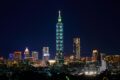 Free Illuminated Taipei 101 and city skyline at night showcasing modern urban architecture. Stock Photo