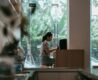 Woman working on laptop in a café—ideal remote work spot for digital nomads with natural light and quiet ambiance