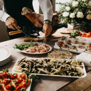 Standing Person Using Fork and Knife on Preparing Food