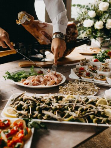 Standing Person Using Fork and Knife on Preparing Food