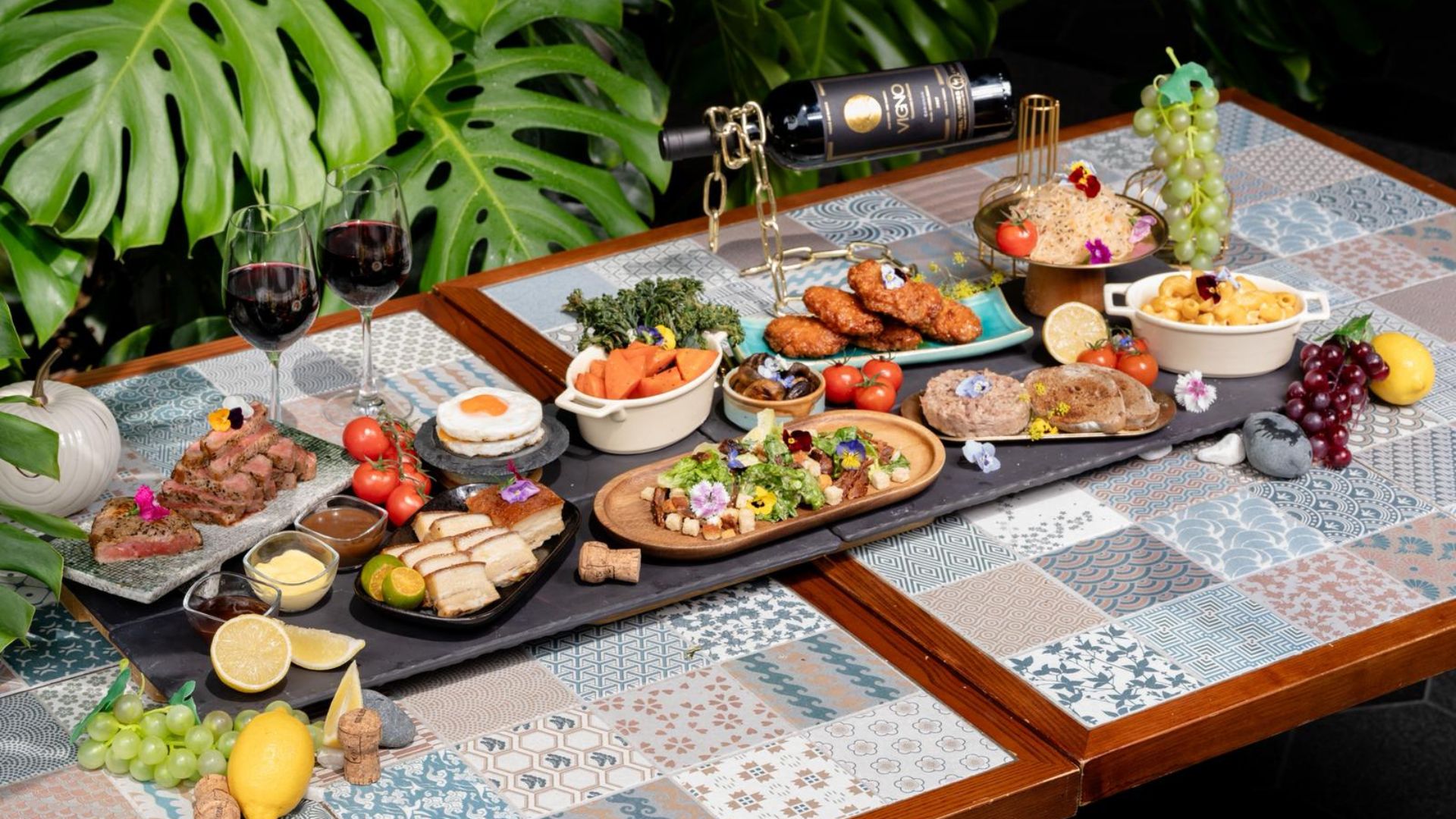 Weekend brunch sharing platter at Mercure Singapore on Stevens featuring meats, sides, and wine on a long table spread