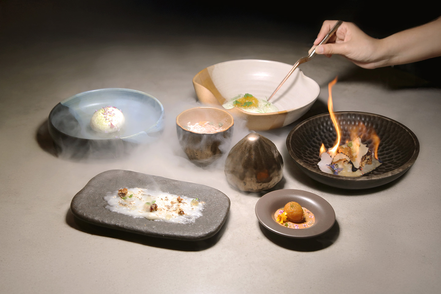 “Homecoming” dessert tasting menu at 2am:dessertbar by Janice Wong, featuring six global-inspired plated desserts with smoke and fire presentation.