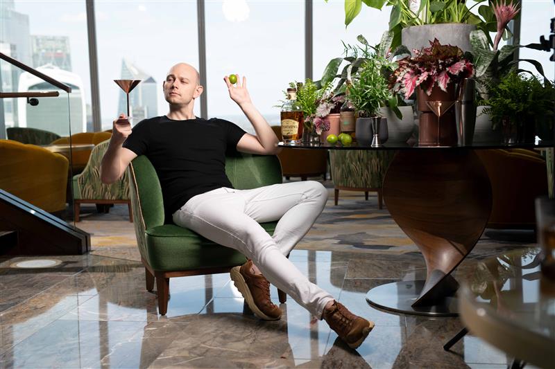 Aidy Smith, UK drinks expert and co-host of The Three Drinkers, sits with cocktails at ANTI:DOTE Singapore for the Edu & Friends guest shift collaboration.