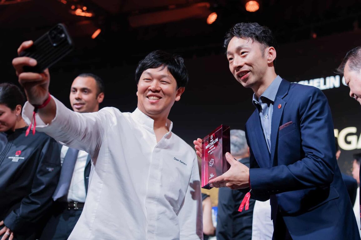 Chefs celebrating with a selfie after receiving Michelin star awards at the Michelin Guide Singapore 2025 ceremony, marking achievements in Singapore’s fine dining scene.