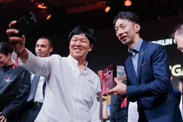 Chefs celebrating with a selfie after receiving Michelin star awards at the Michelin Guide Singapore 2025 ceremony, marking achievements in Singapore’s fine dining scene.