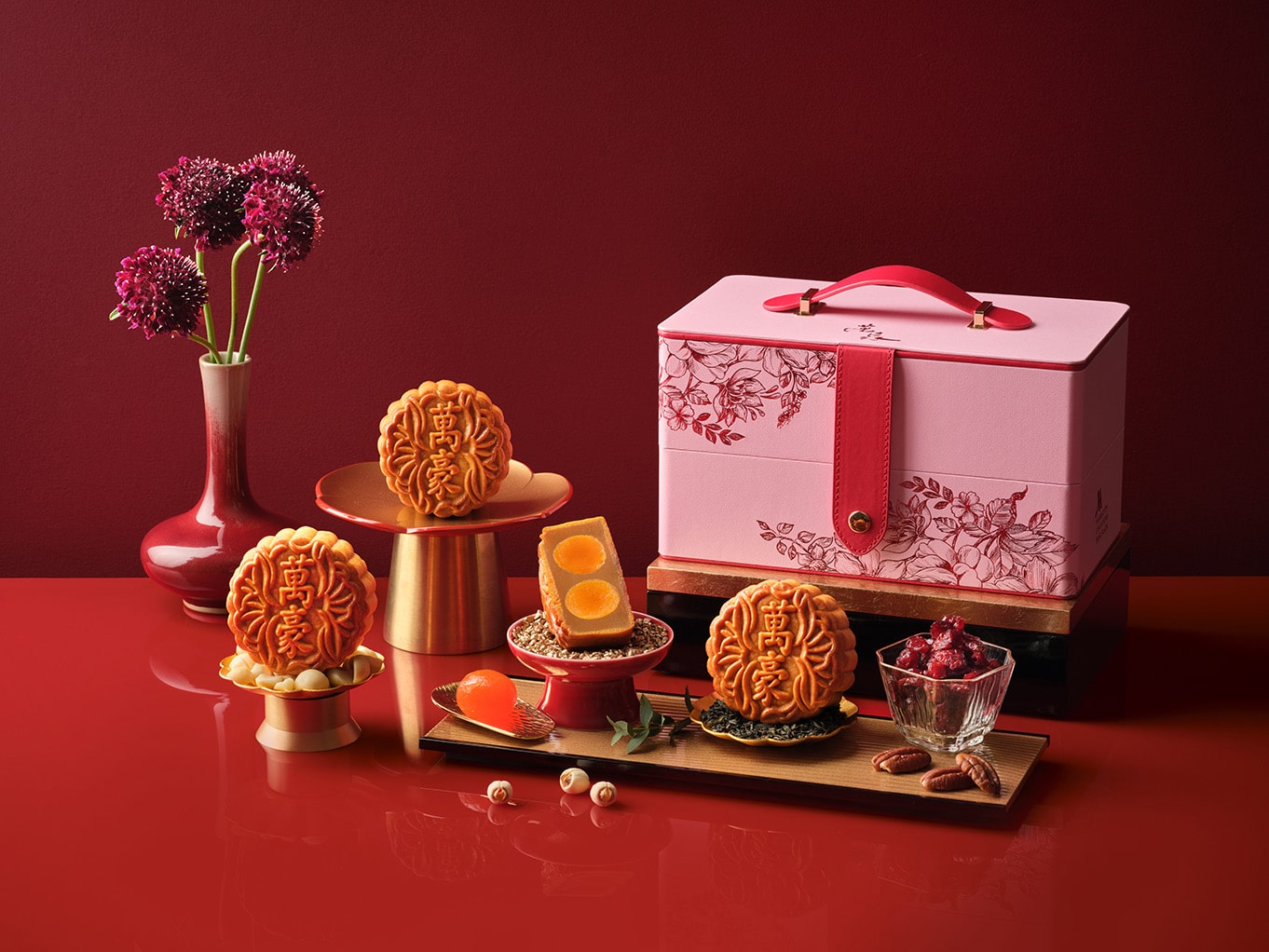 Singapore Marriott Tang Plaza’s 2025 baked mooncake collection styled with a blush pink gift box, showcasing gourmet flavours like black truffle and parma ham.