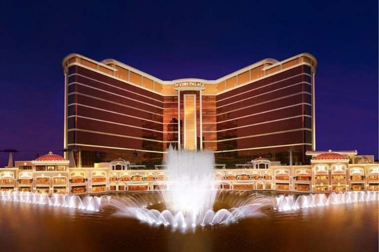 Exterior of Wynn Palace, showcasing the hotel building and the spectacular Performance Lake fountain