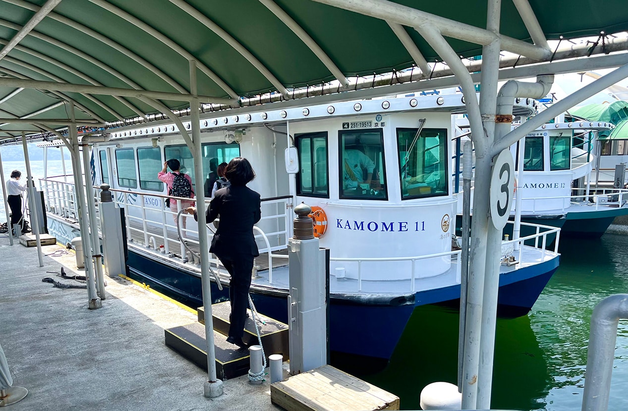 Two-storey sightseeing ferry Kamome 11 at Amanohashidate Pier in Kyoto, Japan, boarding passengers for a cruise across the Asoumi Sea.