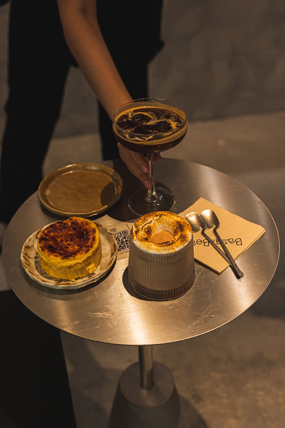 Burnt Basque cheesecake, toasted meringue dessert, and iced espresso cocktail at Basq & Bean café on Beach Road, Singapore